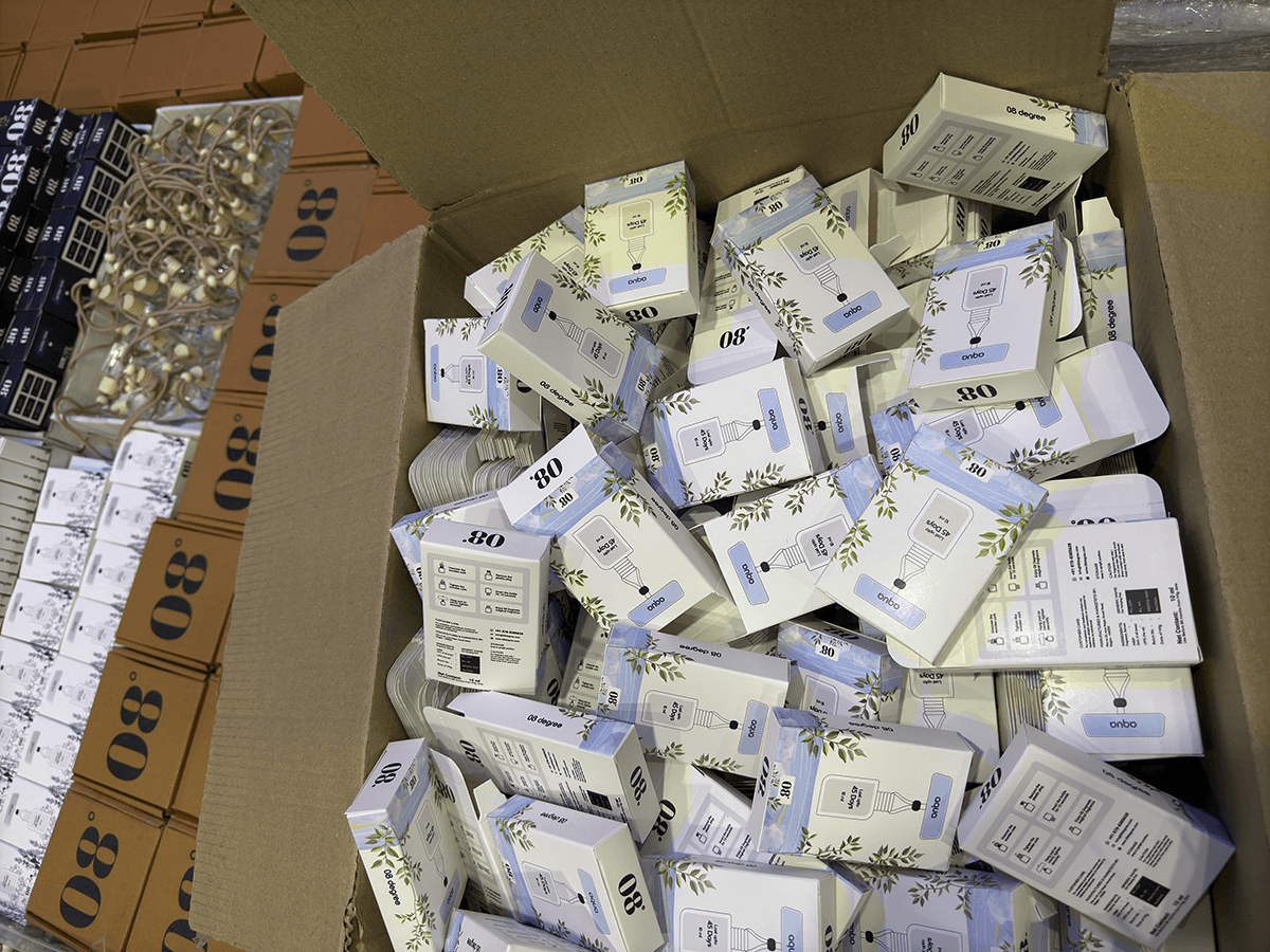 08 Degree Aqua product packaging in a carton beside bottles and shipping boxes