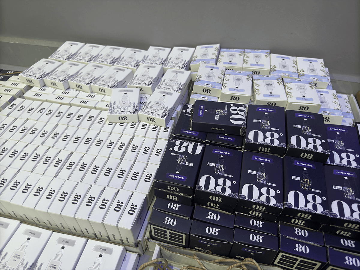 Rows of original 08 Degree Aqua, Musk and Amber Blue boxes in stock